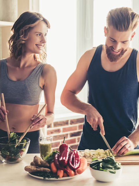 woman and man making healthy food